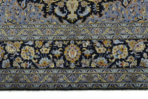 Corner detail of 2000s Kashan rug showing border pattern and Wool pile