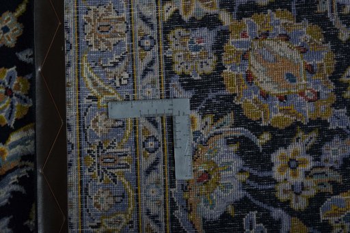 Backside of handmade 2000s Kashan rug showing knot structure and weave density
