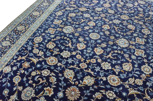 Backside of handmade 2000s Kashan rug showing knot structure and weave density