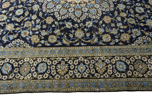 Corner detail of 2000s Kashan rug showing border pattern and Wool pile