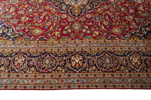 Corner detail of 2000s Kashan rug showing border pattern and Wool pile