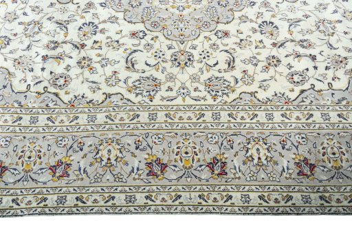 Corner detail of 2000s Kashan rug showing border pattern and Wool pile