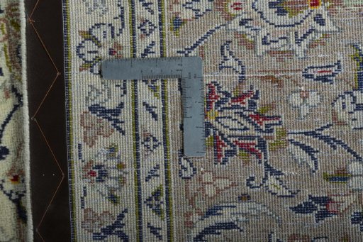 Backside of handmade 2000s Kashan rug showing knot structure and weave density