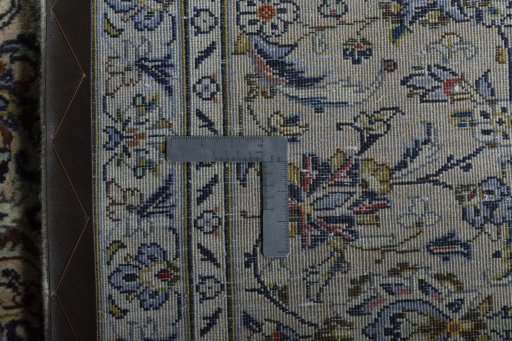 Backside of handmade 2000s Kashan rug showing knot structure and weave density