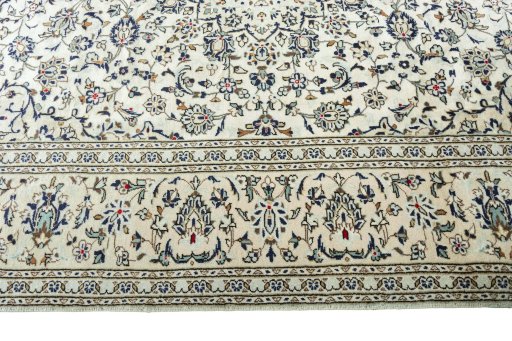 Corner detail of 2000s Kashan rug showing border pattern and Wool pile