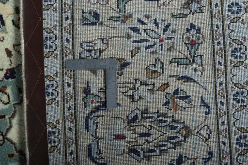Backside of handmade 2000s Kashan rug showing knot structure and weave density