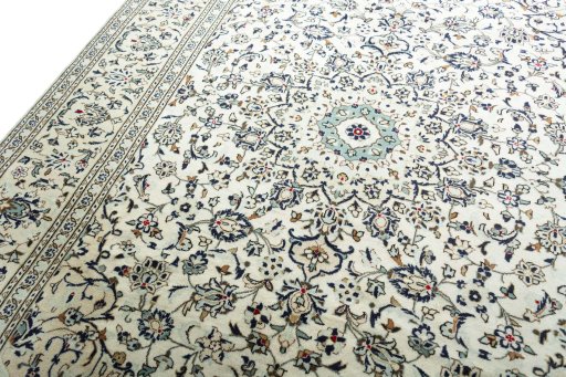 Backside of handmade 2000s Kashan rug showing knot structure and weave density