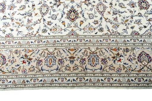 Corner detail of 2000s Kashan rug showing border pattern and Wool pile