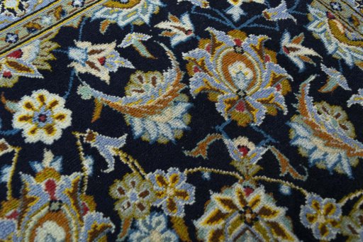 Close-up detail of 2000s Kashan rug from Iran / Persia showing Wool weave