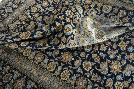 Backside of handmade 2000s Kashan rug showing knot structure and weave density
