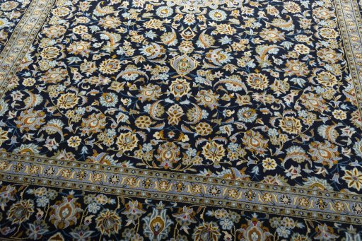 Close-up detail of 2000s Kashan rug from Iran / Persia showing Wool weave