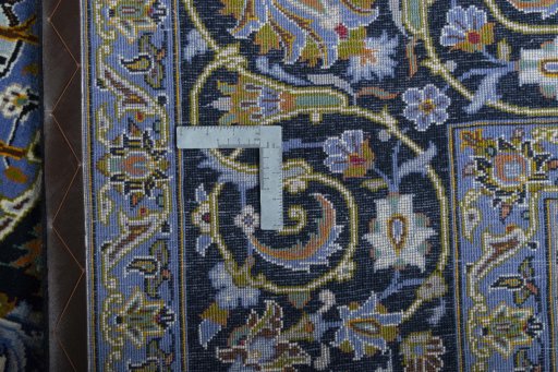 Backside of handmade New Kashan rug showing knot structure and weave density