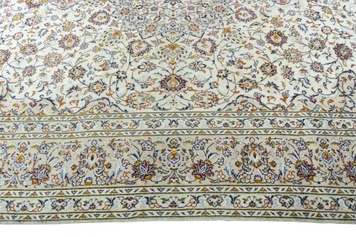 Corner detail of 2000s Kashan rug showing border pattern and Wool pile