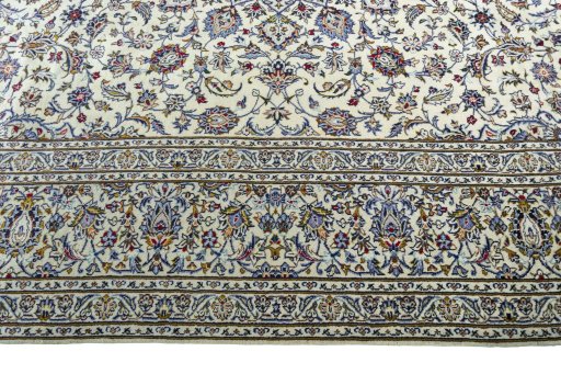 Corner detail of New Kashan rug showing border pattern and Wool pile