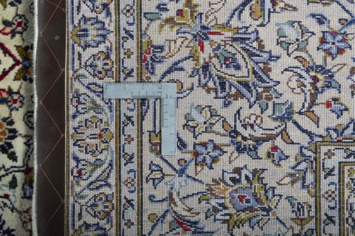 Backside of handmade New Kashan rug showing knot structure and weave density