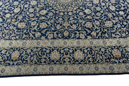 Corner detail of 2000s Kashan rug showing border pattern and Wool pile