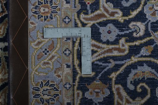 Backside of handmade 2000s Kashan rug showing knot structure and weave density
