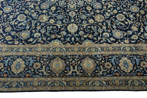 Corner detail of 2000s Kashan rug showing border pattern and Wool pile