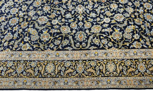 Corner detail of 2000s Kashan rug showing border pattern and Wool pile