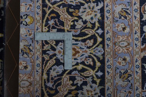 Backside of handmade 2000s Kashan rug showing knot structure and weave density
