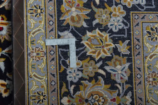 Backside of handmade 2000s Kashan rug showing knot structure and weave density