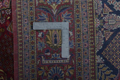 Backside of handmade 1930s Kashan rug showing knot structure and weave density