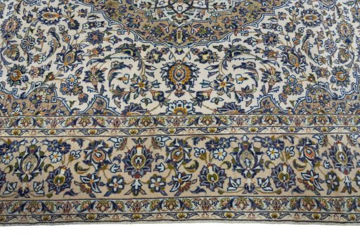 Corner detail of 2000s Kashan rug showing border pattern and Cork pile