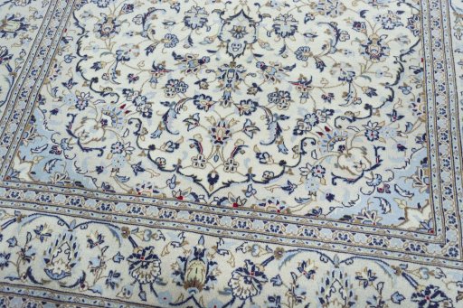 Corner detail of 2000s Kashan rug showing border pattern and Wool pile