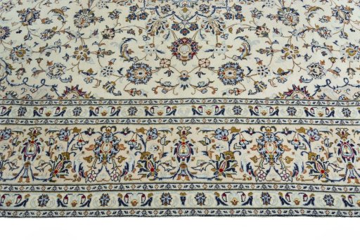 Corner detail of 2000s Kashan rug showing border pattern and Wool pile