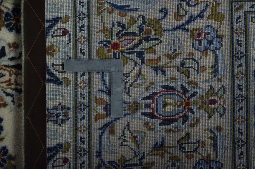 Backside of handmade 2000s Kashan rug showing knot structure and weave density