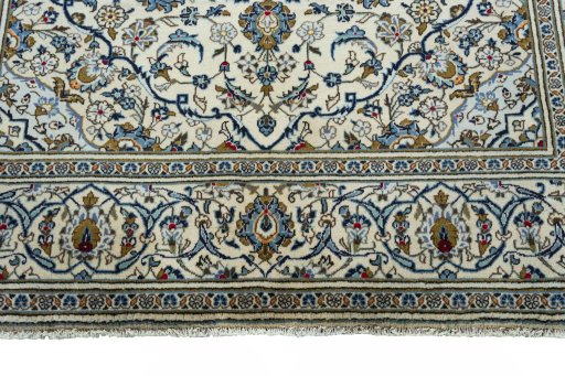 Corner detail of 2000s Kashan rug showing border pattern and Wool pile