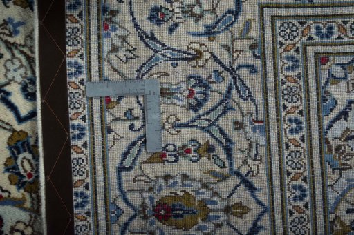 Backside of handmade 2000s Kashan rug showing knot structure and weave density