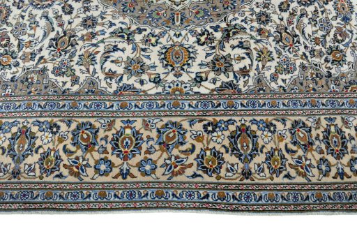 Corner detail of 2000s Kashan rug showing border pattern and Wool pile