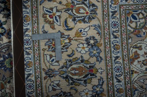 Backside of handmade 2000s Kashan rug showing knot structure and weave density