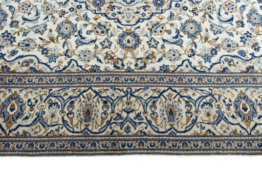 Corner detail of 2000s Kashan rug showing border pattern and Wool pile