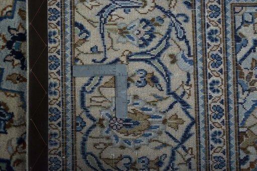Backside of handmade 2000s Kashan rug showing knot structure and weave density