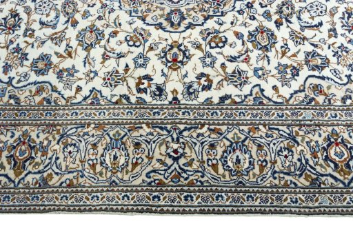 Corner detail of 2000s Kashan rug showing border pattern and Wool pile