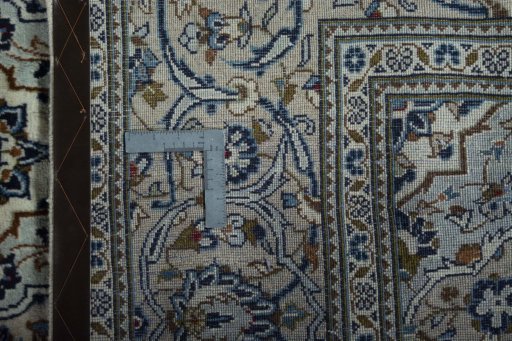 Backside of handmade 2000s Kashan rug showing knot structure and weave density