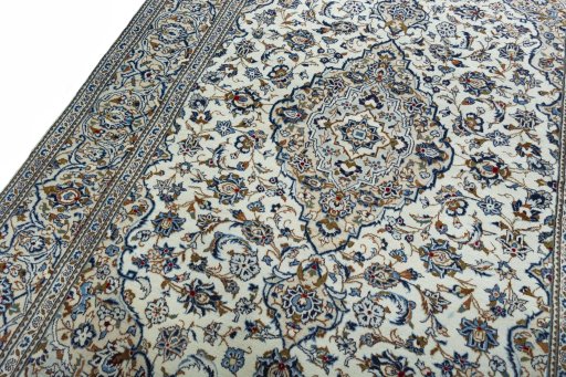 Backside of handmade 2000s Kashan rug showing knot structure and weave density