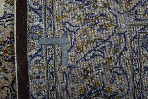 Backside of handmade 2000s Kashan rug showing knot structure and weave density