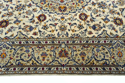 Corner detail of 2000s Kashan rug showing border pattern and Cork pile