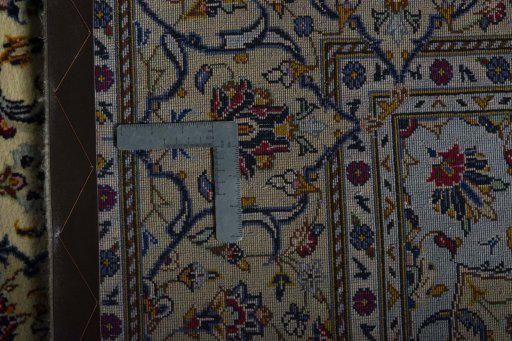 Backside of handmade 2000s Kashan rug showing knot structure and weave density