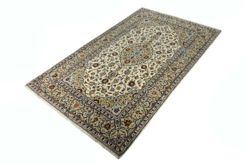 Corner detail of 2000s Kashan rug showing border pattern and Cork pile