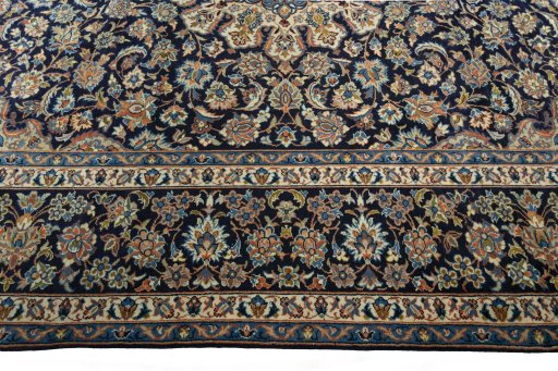 Corner detail of 2000s Kashan rug showing border pattern and Wool pile