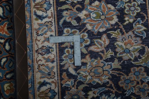 Backside of handmade 2000s Kashan rug showing knot structure and weave density