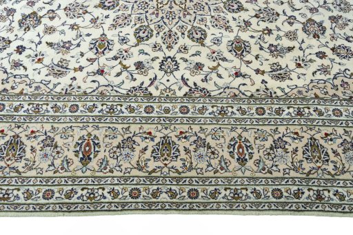 Corner detail of 2000s Kashan rug showing border pattern and Wool pile