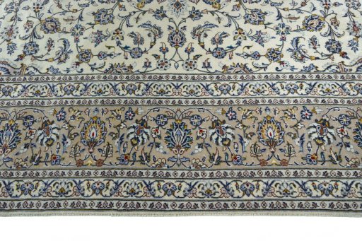 Corner detail of 2000s Kashan rug showing border pattern and Wool pile