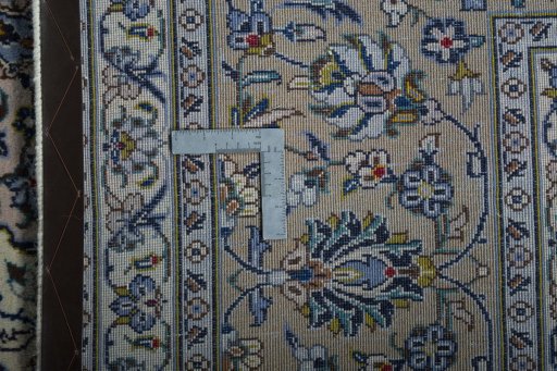 Backside of handmade 2000s Kashan rug showing knot structure and weave density