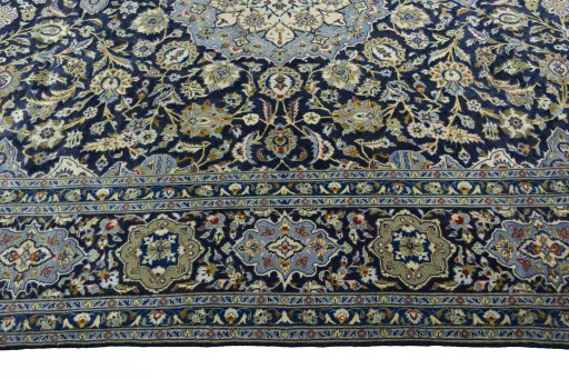 Corner detail of 2000s Kashan rug showing border pattern and Wool pile