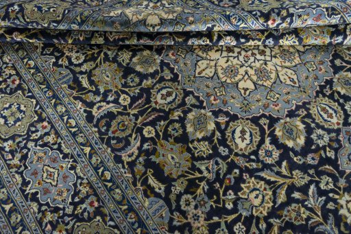 Close-up detail of 2000s Kashan rug from Iran / Persia showing Wool weave
